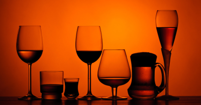 alcohol in a variety of glasses lined up