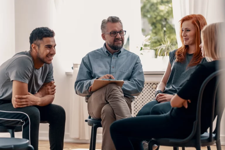 Addiction counselor hosts group therapy session at an inpatient rehab