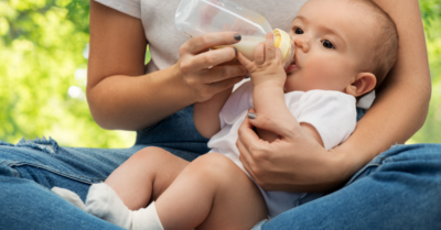 A woman feeding her baby