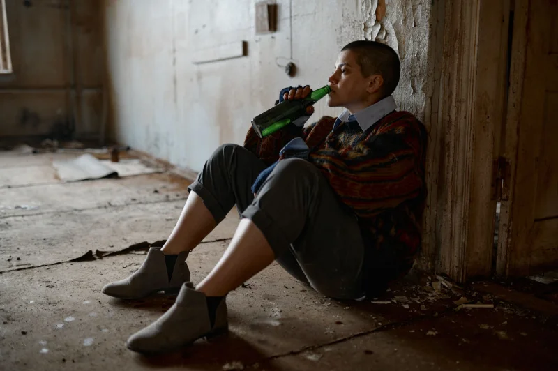 Person drinking alcohol alone in a distressed state, representing co-occurring disorders and the challenges of dual diagnosis treatment